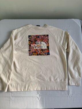 The North Face Women's Cream Pullover with Blue Logo and Orange Accent
